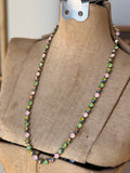 Full length view of pink green and iridescent crystal necklace