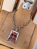 Angled view of Alice Dallas tiger portrait pendant necklace on silver chain