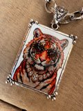 Close up of Alice Dallas tiger portrait pendant wearing leopard sunglasses and crystal necklace