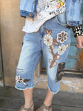 Hidden Trails Shorts by Jaded Gypsy with floral appliqués and camouflage cargo pockets