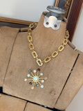 Jennifer Thames gold chain necklace with multicolor gemstone sunburst pendant