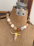 Jennifer Thames chunky neutral beaded necklace with gold and blush bull skull pendant