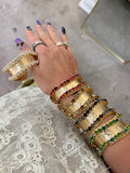 WAFA textured gold cuffs with crystal borders in clear, green, black smoke, champagne, and red