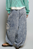 Washed blue jogger pants with crochet patch details, back view